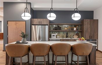 Resident lounge with kitchen, dining space and fireplace